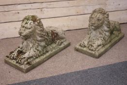 Pair weathered composite stone recumbent garden lions, W32cm, H50cm,