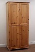 Solid pine double wardrobe, two doors enclosing fitted interior, bun feet, W82cm, H180cm,