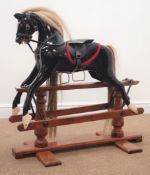 19th century painted rocking horse, saddle stirrups and briddle, trestle base, L90cm,