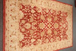 Large Persian style red ground rug, floral field,