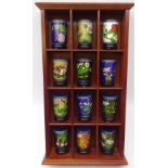 Set of twelve Chinese Cloisonne cylindrical vases on stands, on mahogany wall mounted display shelf,