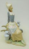 Large Lladro figure of a Milkmaid seated on a wheelbarrow,