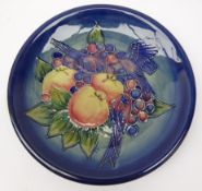Moorcroft plate decorated with finches amongst fruit,