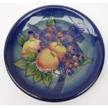 Moorcroft plate decorated with finches amongst fruit,