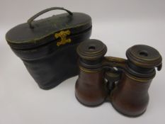 Pair of 19th century leather bound binoculars, the adjustable optics with three settings for Marine,