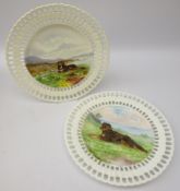 Pair late Victorian reticulated cabinet plates hand painted with dogs in a moorland landscape,