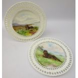 Pair late Victorian reticulated cabinet plates hand painted with dogs in a moorland landscape,