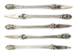 Set of five cast silver nut picks London 1918 with classical head and claw decoration