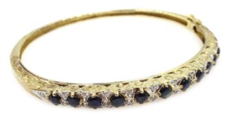 Sapphire and diamond gold hinged bangle, hallmarked 9ct Condition Report 10.