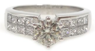 18ct white gold round brilliant cut diamond ring, with princess cut diamond shoulders, stamped 750,