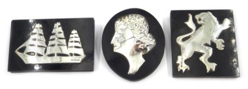Three silver mounted ebonised plaques depicting a sailing ship, lion and female portrait,