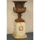 Large cast iron urn, gadrooned top and scroll body with lions mask handles,