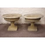 Pair composite stone urn planters, circular form with egg and dart rim and gadroon underside,