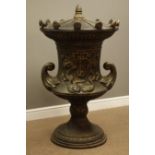 Large bronze finish cast iron lidded garden urn, decorated with foliage swags and dolphins,