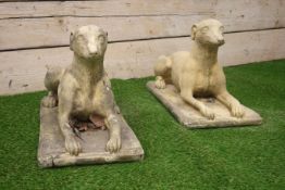 Pair composite stone recumbent dogs,