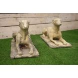 Pair composite stone recumbent dogs,