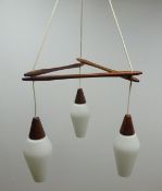 1970s Scandinavian teak three light centre light fitting, with white frosted tapered glass shades,