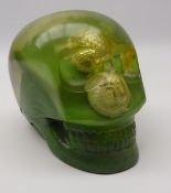 Coloured resin moulded skull, internally decorated with golf balls, coins etc,