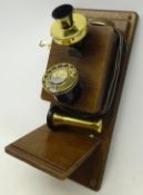 Commemorative wall mounting telephone on wooden backboard with brassed fittings,