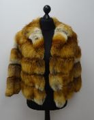 Short fox fur coat with suede spacers,