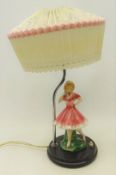 Art deco style bakelite table lamp, mounted with a ceramic figure of a young girl,