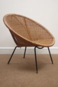 1960s wicker basket chair on black finish metal supports,