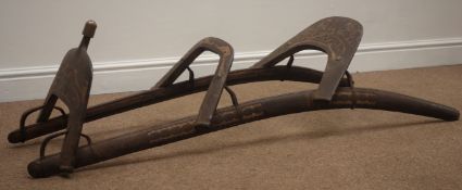 Wooden framed Dromedary saddle with pierced metal decoration, on curved supports, L132cm,