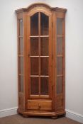Polished pine corner display cabinet, arched projecting cornice, glazed door,