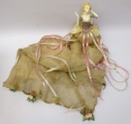Pincushion style doll by Wayne Kleski, clothed in a long dress with ribbon and rose embellishments,