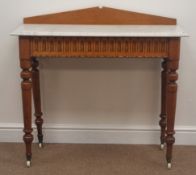 Late Victorian golden oak marble top washstand, shaped raised back, carved frieze, turned supports,