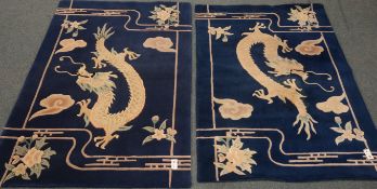 Two Chinese deep pile blue and white rugs decorated with Dragons,