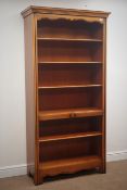 Cherry bookcase, projecting cornice, four adjustable shelves, shaped apron, solid end supports,