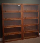 Pair 20th century teak cased five tier bookcase storage units with hinged up and over glazed doors,