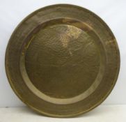 Large Eastern brass wall charger, chased with a Leopard, Elephant and other animals,