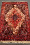 Kurdish red ground rug, central medallion,