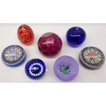 Seven glass paperweights comprising two Caithness 'Fireball' & 'Highland Spray',