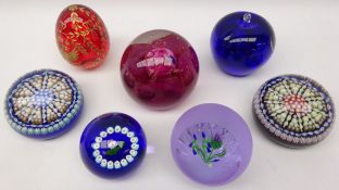 Seven glass paperweights comprising two Caithness 'Fireball' & 'Highland Spray',