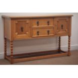 Early 20th century light oak sideboard, two drawers flanked by two cupboards, on bobbin,