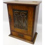 Arts & Crafts oak smokers cabinet with embossed stylized copper panel and fitted interior,