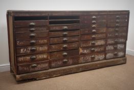 19th century haberdashery chest, thirty two graduating drawers, plinth base, W212cm, H99cm,