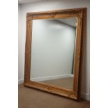 Large rectangular bevelled edge wall mirror in ornate swept gilt frame,