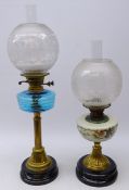 Two Victorian brass oil lamps, one with reeded blue glass well and frosted glass globular shade,