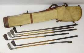1930's canvas golf bag with five hickory shafted clubs including unusual white metal combined