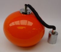 Retro orange glass light fitting, of globular form with rise and fall action and chrome mounts,