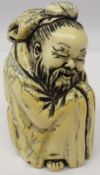Japanese Meiji period carved ivory Okimono of a seated man, character mark to underside, H7.