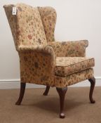 Original Parker Knoll wingback armchair, upholstered in a floral fabric, cabriole supports,