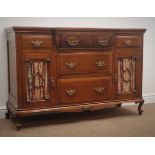 Edwardian walnut sideboard, five drawers, two glazed cupboard doors, carved and shaped apron,