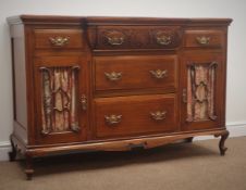 Edwardian walnut sideboard, five drawers, two glazed cupboard doors, carved and shaped apron,
