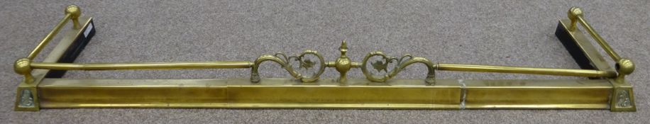 Telescopic brass fire fender with central scroll decoration,