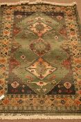 Persian style green ground rug,
